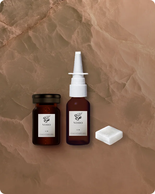 Sermorelin vial and nasal spray on a marbled background